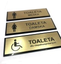 Tabliczka na drzwi TOALETA – męska, damska, dla niepełnosprawnych – złoto szczotkowane + czarne plexi – 21 × 7 cm